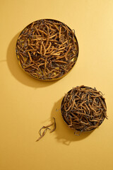 Canvas Print - Golden dish containing Dried Cordyceps Sinensis decorated on beige background. Cordyceps has beneficial effects on the human body