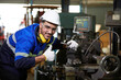 © offsuperphoto - factory worker or technician smiling and thumbs up pose beside lathe machine in factory