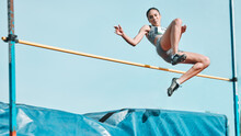 High Jump, Woman And Fitness With Exercise, Sport And Athlete In A Competition Outdoor. Jumping, Workout And Training For Performance With Action, Energy And Contest With Female Person And Athletics