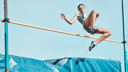 high jump, woman and fitness with exercise, sport and athlete in a competition outdoor. jumping, wor
