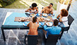 © Anela/peopleimages.com - Food, top and friends in house backyard to relax on holiday celebration or vacation in summer together. Party, home or happy people eating to bond at table in conversation for lunch or brunch meal