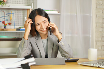 Wall Mural - Businesswoman contacting customers by phone