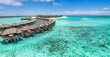© icemanphotos - Aerial view of Maldives island, luxury water villas wooden pier path resort. Beautiful sky and ocean bay beach background. Summer vacation travel destination. Paradise aerial landscape panoramic coast