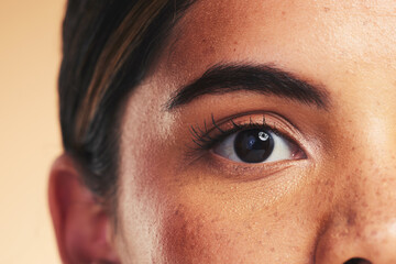 Woman, eye macro and beauty in studio portrait with beauty, cosmetics or natural glow on face by background. Girl, model and facial zoom with change, melasma or skin for microblading, shine and clean