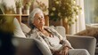 © MiguelAngel - Relaxed senior woman sitting on sofa at home.
