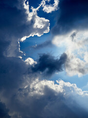 dark and white clouds on a background of blue sky