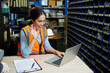 © offsuperphoto - worker working on laptop computer and video call online to someone in the warehouse storage