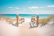 Wooden Boardwalk Leading To A Beach. Light-colored Wood, Railings, Dune Grass. Ocean And Blue Sky In The Background. Bright And Sunny Mood.