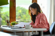 © Prathankarnpap - Happy asian businesswoman using laptop working on new startup project at her office