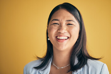 Poster - Face, happy and Asian woman, designer and entrepreneur in studio isolated on a yellow background mockup space. Portrait, funny and creative professional, worker laugh and startup employee in Cambodia