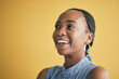 © Charlize Davids/peopleimages.com - Thinking, smile and black woman in creative business studio isolated on a yellow background mockup space. Vision, happy and African designer, entrepreneur and employee worker planning startup idea.