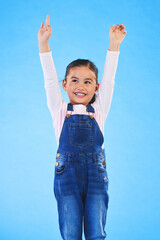 Wall Mural - Success, girl child and champion, winner and achievement with happiness and excited isolated on blue background. Cheers, yes and winning with celebration, pride and happy kid with arms up in a studio