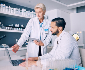 Scientist, mentor and training on computer and tablet for data analysis, laboratory report and pharmaceutical research. Science or medical woman and man talking, medicine support and digital solution