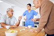 © Sharne/peopleimages.com - Nurse, senior and fighting over a game of dominoes with people in a retirement home for assisted living. Healthcare, medical and a female medicine professional looking at upset old men arguing