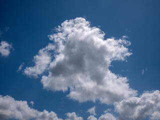 white fluffy clouds in the deep blue sky background