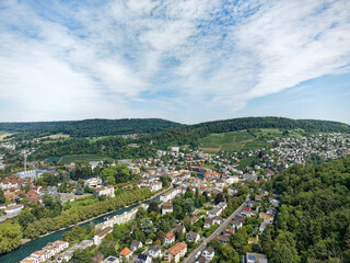 Wall Mural - Aerial view of Swiss City of Baden with Industrial district, Limmat River and bridge on a sunny summer noon. Photo taken August 19th, 2023, Baden, Canton Aargau, Switzerland.