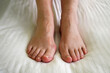female legs with problem with women's feet, bunion toes in bare feet. Hallus valgus
