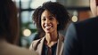 © Fred - Smiling black female politician talking to her colleagues