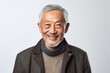 © Anne-Marie Albrecht - Lifestyle portrait of a Chinese man in his 70s in a white background wearing a chic cardigan