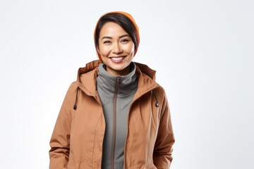 Wall Mural - Portrait of a smiling asian woman wearing winter jacket isolated on a white background