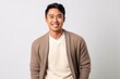 © Anne-Marie Albrecht - Portrait of a happy young asian man standing against white background