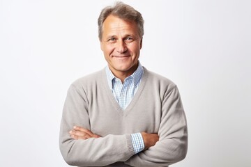 Medium shot portrait of a Russian man in his 50s in a white background wearing a chic cardigan