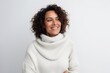 © Anne-Marie Albrecht - Medium shot portrait of a Brazilian woman in her 40s in a white background wearing a cozy sweater