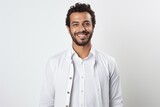 Fototapeta Do akwarium - Portrait of a smiling young man in white shirt standing over white background
