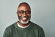 © Anne-Marie Albrecht - smiling african american man in eyeglasses looking at camera isolated on grey