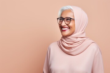 Wall Mural - Portrait of beautiful asian muslim woman wearing hijab and eyeglasses smiling at camera