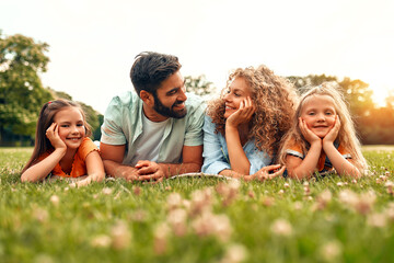 Wall Mural - Happy family relaxing in the park