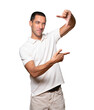 © agongallud - Friendly young man making a gesture of taking a photo with the hands