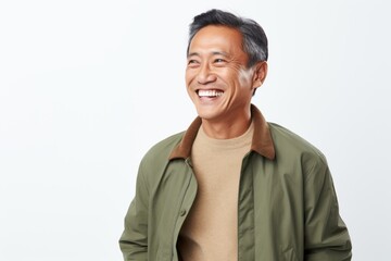 Portrait of a happy senior asian man smiling against white background