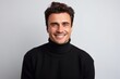 © Eber Braun - Portrait of a handsome young man in black sweater smiling and looking at camera isolated over white background