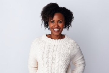 Wall Mural - Portrait of a smiling african american woman standing against grey background