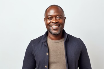 Wall Mural - Portrait of a smiling african american man against white background