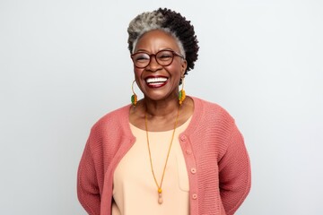 Wall Mural - Portrait of happy afro american woman in pink sweater and eyeglasses smiling at camera