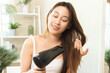 Hair Dryer, beautiful happy, asian young woman, girl hand in using, holding hairdryer to dry, blowing blonde long straight after shower at home. Hairdressing, hair treatment isolated on background.