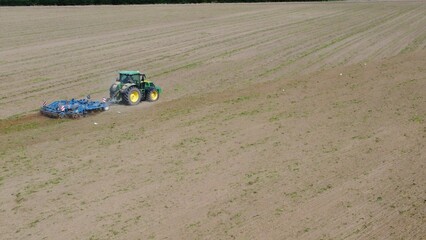 Poster - Closeup of An agricultural tractor  in a field in a rural France