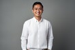 Portrait of a Indonesian man in his 30s in a minimalist or empty room background wearing a chic cardigan