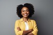 © Eber Braun - smiling african american woman in yellow jacket on grey background