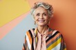 Portrait of a Russian woman in her 60s in an abstract background wearing a chic cardigan