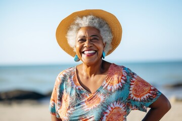 Portrait of a Nigerian woman in her 90s in a beach background wearing a fun graphic tee