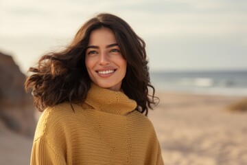 Wall Mural - Portrait of a Saudi Arabian woman in her 40s in a beach background wearing a cozy sweater