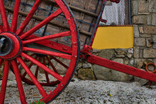 Partial View Of A Horse Cart With Red Wheels.
