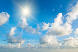Fototapeta Na sufit - bright sun, blue sky and light clouds.