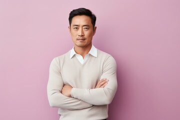 Wall Mural - Portrait of a Chinese man in his 30s in a pastel or soft colors background wearing a chic cardigan