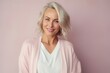 © Hanne Bauer - Medium shot portrait of a Russian woman in her 40s in a pastel or soft colors background wearing a chic cardigan