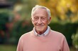 © Hanne Bauer - Portrait of a Russian man in his 80s in a pastel or soft colors background wearing a chic cardigan