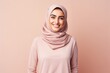 © Hanne Bauer - Portrait of a Saudi Arabian woman in her 30s in a pastel or soft colors background wearing a cozy sweater